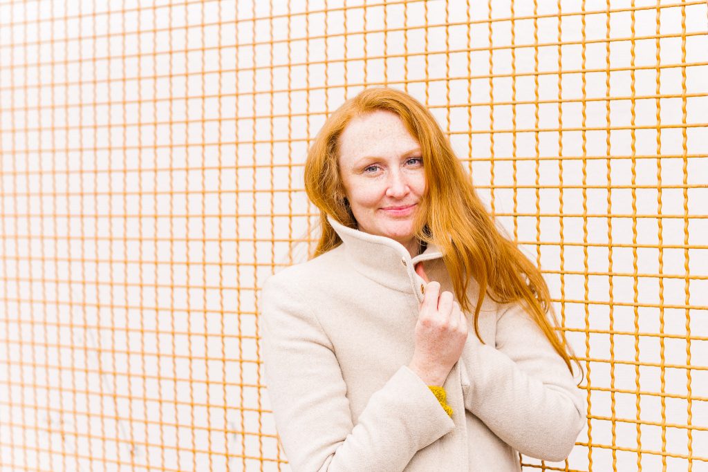 Damenportrait in Bremenn Finndorf. Ton in Ton, die rot-orangen Haare passen genau zum Hintergrund.